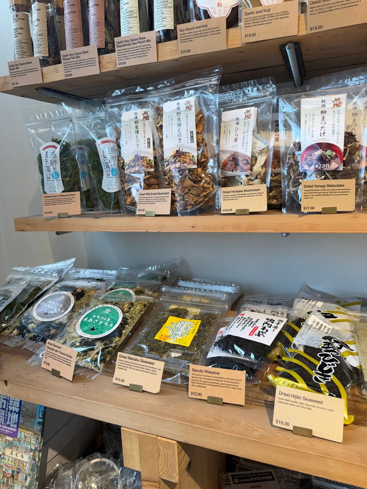 Wooden shop shelves of dried seaweed and mushrooms with handwritten price cards